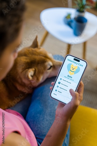 Hispanic Person uses veterinary care app to manage dog's health