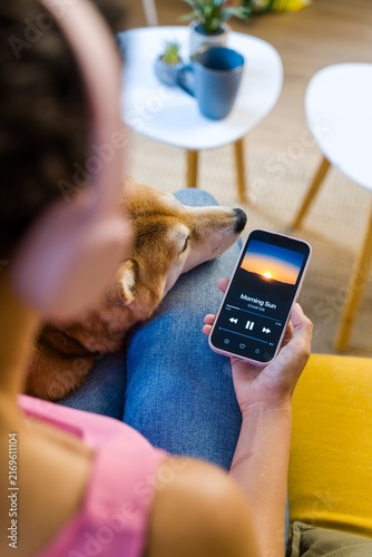 Hispanic Person relaxing with dog