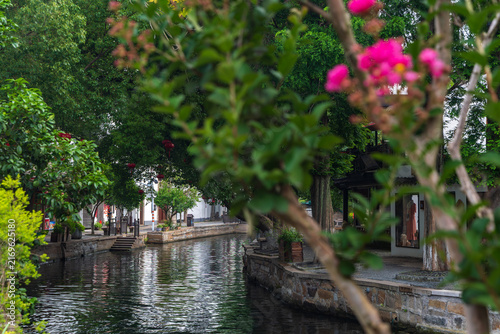 The river channels of Jiangnan water towns are veiled by blooming crape myrtle flowers.