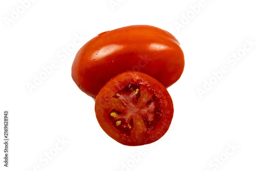 Konstfotografi One whole red roma tomato and one sliced tomato cross-section showing internal s