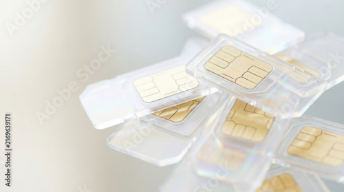 Stack of multiple SIM cards overlapping with golden chip close up