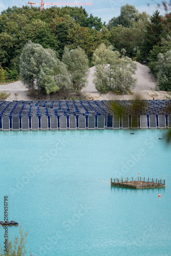 Photography Vertical floating solar panels on the Gilching quarry lake in Bavaria, Germany,