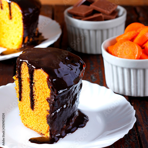 Brazilian carrot cake dessert with chocolate on a white plate, with other slices included in the composition.