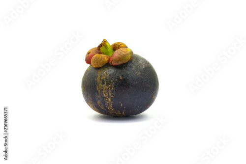 The outer peel of the mangosteen turns a deep purple against a white background.