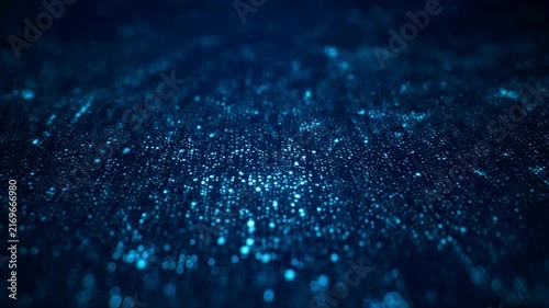 Abstract blue particles shimmering in dark water with subtle light effects