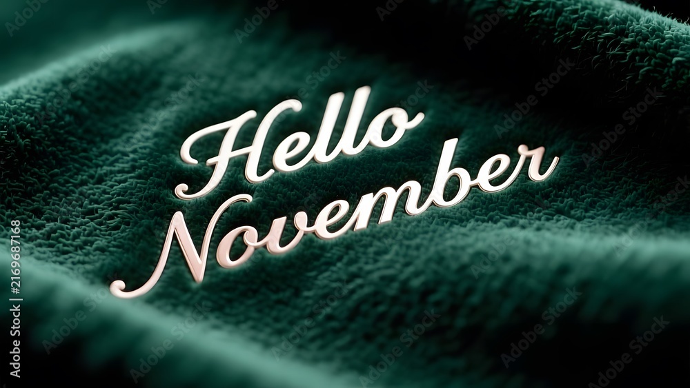 Fototapeta premium Hello November text on dark green velvet fabric, cozy autumn seasonal greeting, soft plush texture with elegant script lettering