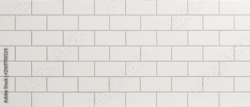Seamless white subway tile pattern background texture. Clean, modern, and minimalist ceramic surface with light gray grout lines, ideal for kitchen, bathroom, or interior design. A