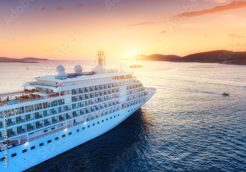 Luxury Cruise Ship Sailing at Sunset on the Open Sea