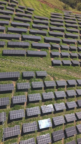 Aerial view of a solar energy farm on a mountain.