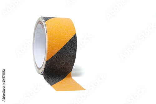 Bild auf Leinwand view of black and yellow anti-slip adhesive safety tape rolled into a compact co