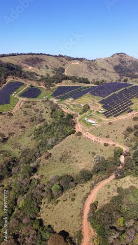 Aerial view of a solar energy farm on a mountain.