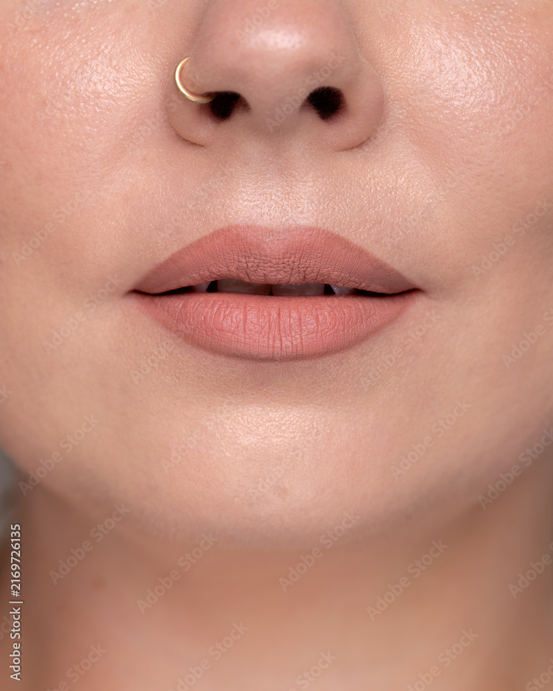 Obraz premium Natural nude matte lipstick on lips close up