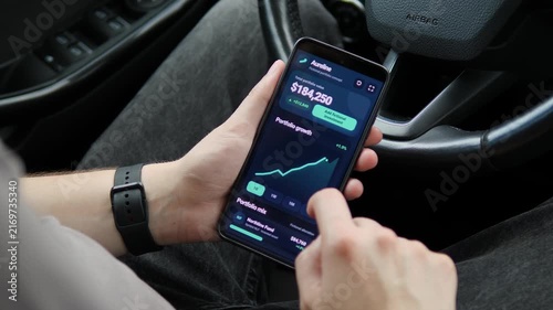 Investor reviews rising portfolio performance on a smartphone, capturing mobile wealth management, market growth and the shift toward real-time personal finance.