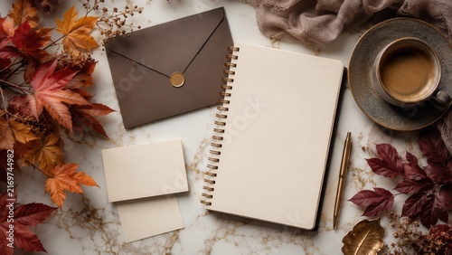 Elegant autumn stationery mockup with spiral notebook envelope cards coffee cup and maple leaves on marble desk