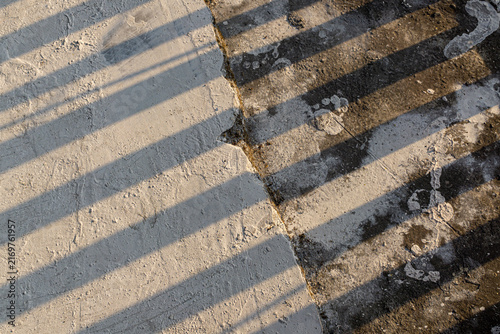 фотографія Fence Shadow Lines on Unpolished Rough Marble Stone Floor Texture Background