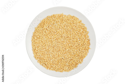Oatmeal on a ceramic plate isolated on a white background. Vegetarian organic food. Grain for vegetarians. Contains soluble fiber, which improves stomach and intestinal function. Top view.