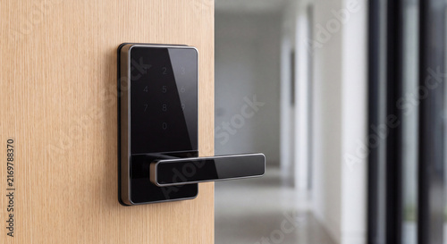 Black electronic keyless smart door lock with biometric fingerprint scanner mounted on contemporary wooden entrance door