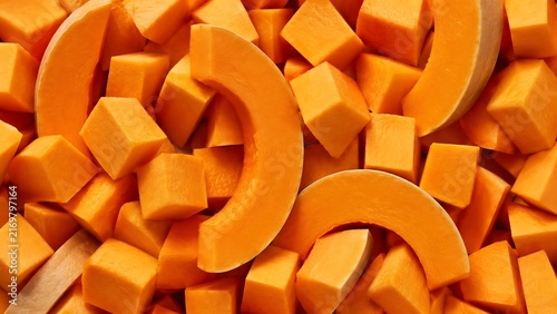 Diced orange butternut squash pieces with crescent slices for healthy cooking meal.