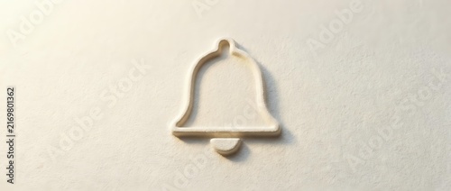 Metallic bell icon with clapper casting shadow on neutral beige