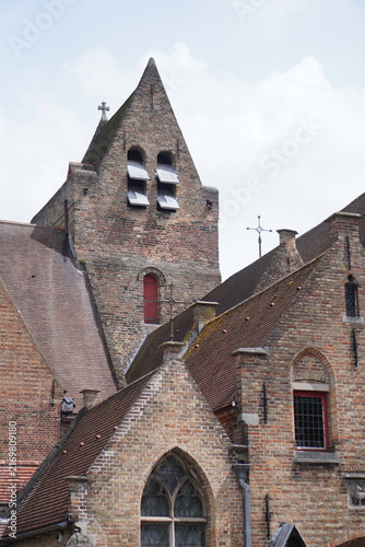 фотографія Medieval brick church with distinctive bell openings and traditional European architecture