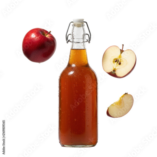 Vintage glass bail-top bottle with condensation, amber cider, and levitating deep crimson apples (whole, half, wedge) against a pristine high-key white background, freshness advertising concept