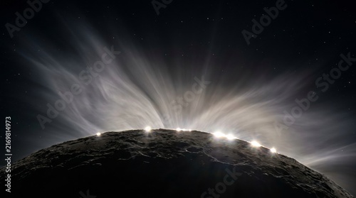 Bailey's beads and coronal streamers over cratered lunar surface in total eclipse