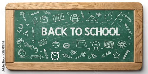 Young Female Teacher Writing on Green Chalkboard in Classroom,Female teacher teaching students in classroom setting