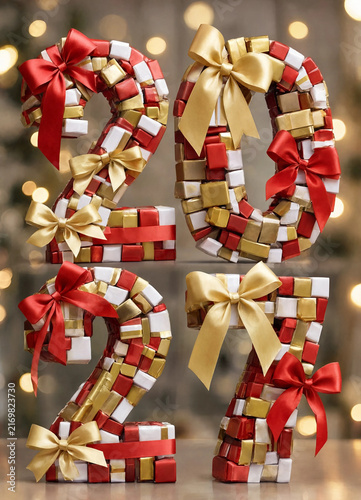 Candy cane-style numerals decorated with red, gold, and white gift bows against a softly glowing festive background.