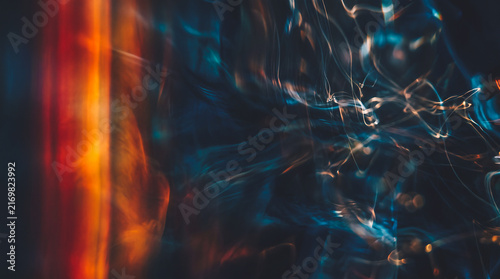 Abstract swirling light streaks in deep blue and fiery orange tones