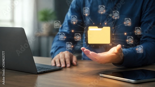 Professional managing digital document storage and data organization in modern office workspace.