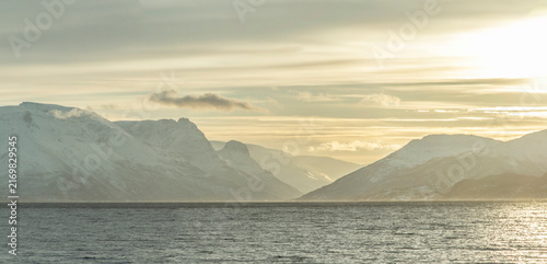 Photography Snowy mountains and fjord in Troms County, Norway during winter