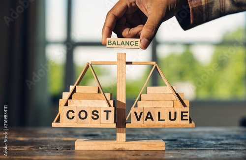 Balance Between Cost and Value Concept Wood Blocks.