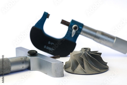 Photography Precision outside micrometer and depth gauge with turbocharger compressor impeller on white background