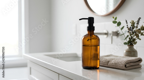 Amber Glass Soap Dispenser and Textured Towel on a Modern Minimalist Bathroom Vanity Countertop