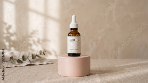 Amber glass dropper bottle of rosehip facial oil by serene botanicals placed on a minimalist pink pedestal against a soft, neutraltoned background with natural light and eucalyptus shadows