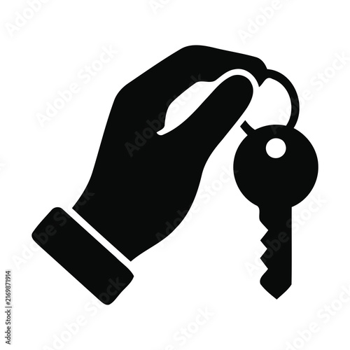 Black silhouette hand holding metal door keys for real estate access.
