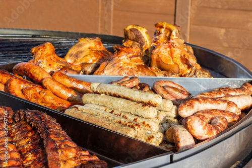 Close-up of grilled sausages, hot dogs, and pieces of meat. Street food.