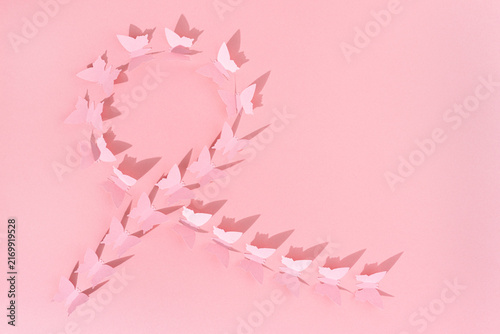 pink paper butterflies ribbon breast cancer awareness minimalist abstract background. copy space