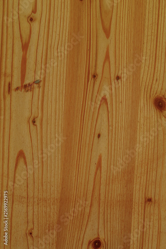 Fotografie Close-up of a warm, natural pine wood surface with prominent grain patterns and knots