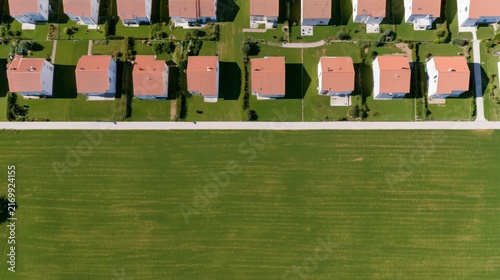 Modern Residential Houses with Red Roofs and Green Lawns