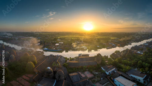 Bild auf Leinwand Aerial panoramic view of Mang Thit pottery village with traditional red brick kilns along the river in Vinh Long, Vietnam