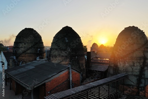 Quadro su tela Aerial panoramic view of Mang Thit pottery village with traditional red brick kilns along the river in Vinh Long, Vietnam