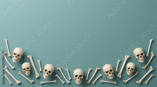 Top view of human skulls and bones arranged as a frame for a spooky halloween background design