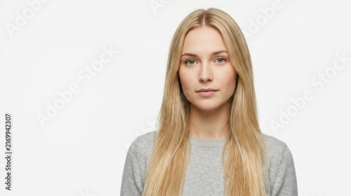 Portrait of a young beautiful blonde woman looking at the camera with a calm expression