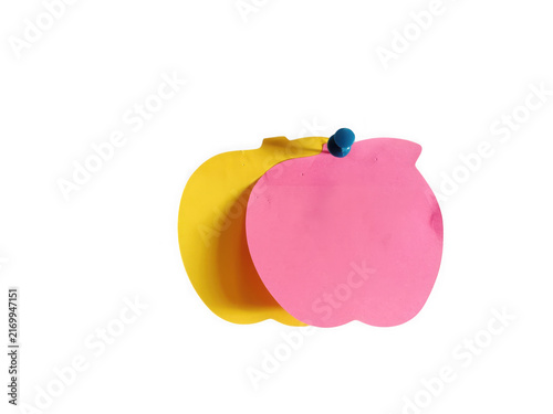 Yellow and pink apple shaped sticky notes attached with a push pin