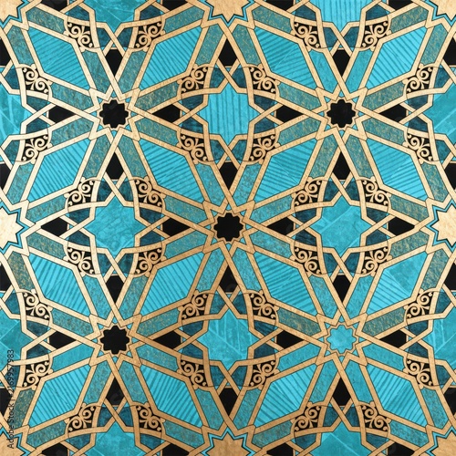 Intricate geometric islamic pattern with turquoise and gold accents