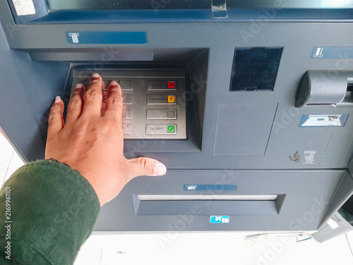 Fotografía Human hand inserting bank card into atm for cash withdrawal