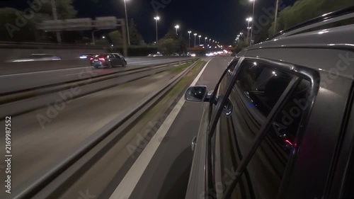 SUV / car driving through highway / freeway at night side mirror POV