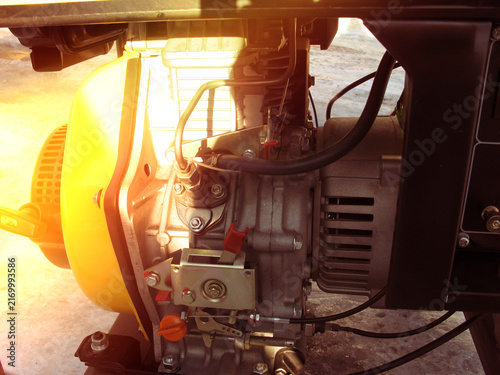 Generator placed on the ground with snow in the background during winter daylight
