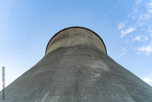 Bild auf Leinwand Concrete cooling towers of an old power plant against a blue sky